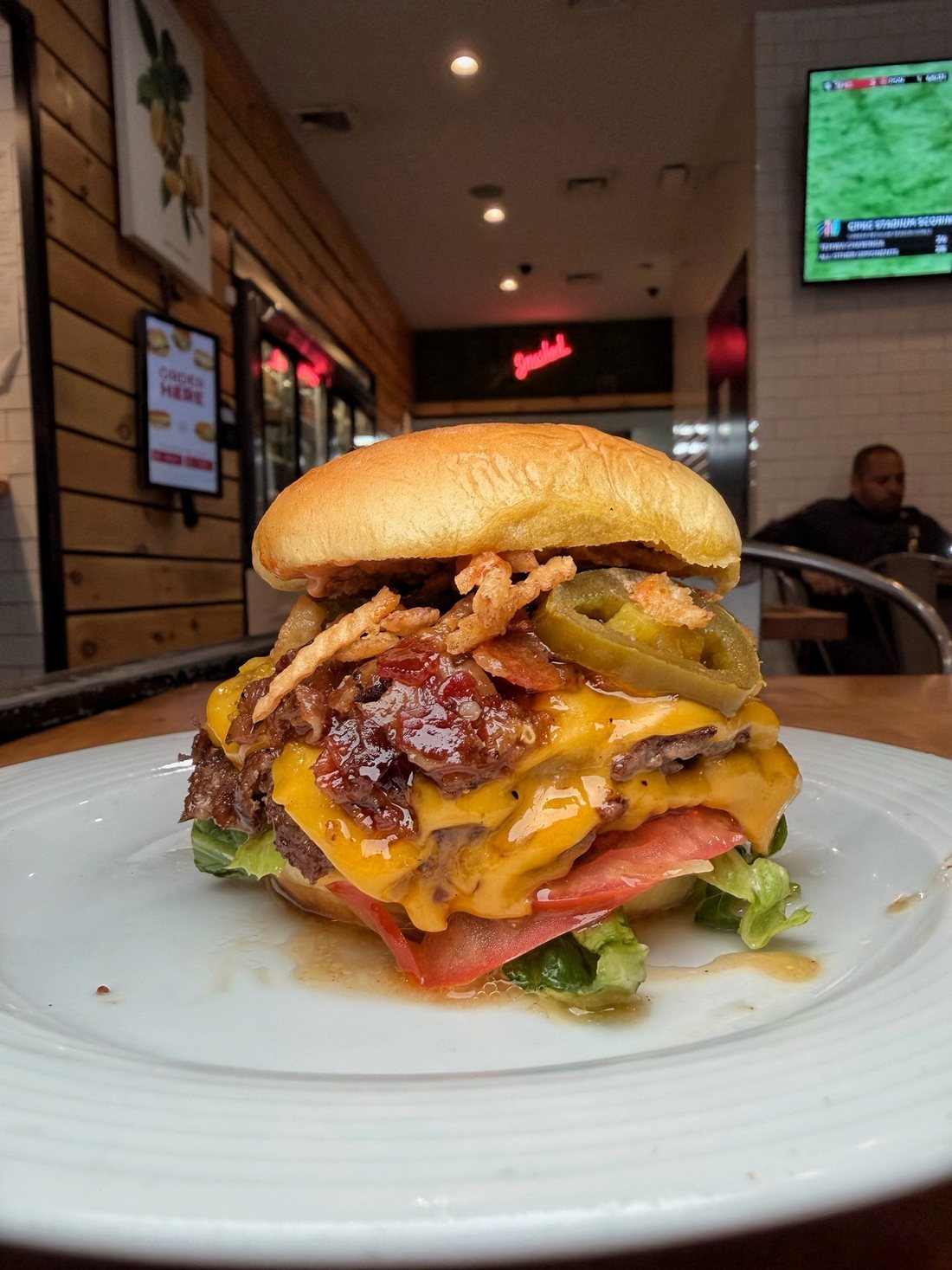 A Handcraft burger on the counter, the dining room behind it